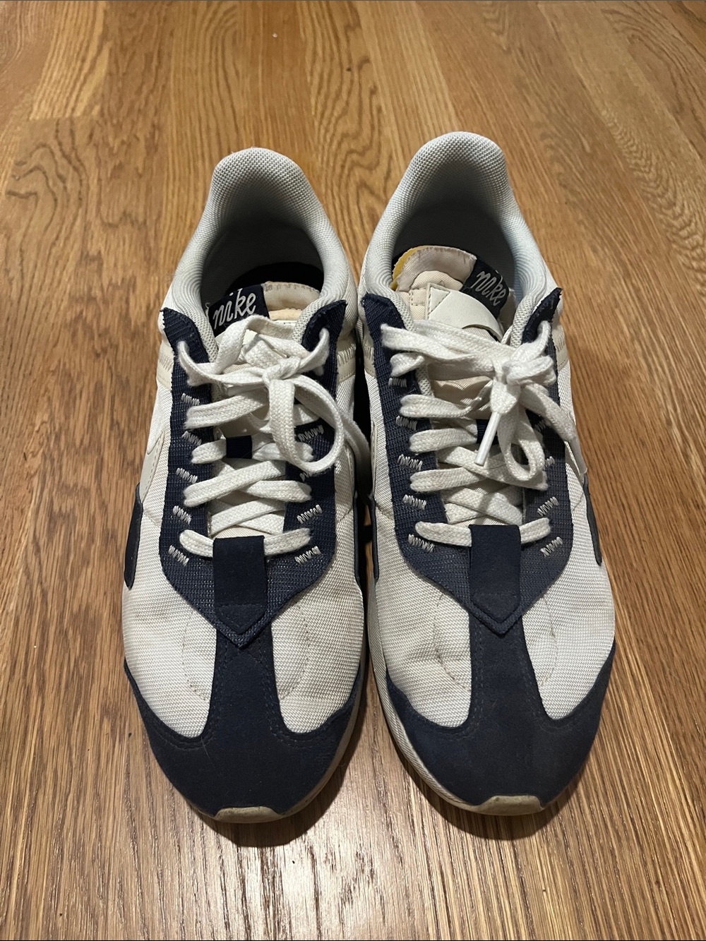 Nike men’s white and navy sneakers